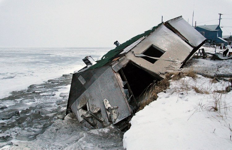 An abandoned house at the west end of Shishmaref, Alaska, sits on the beach after sliding off during a fall storm in 2005. Joel Clement, who worked with Alaskan communities affected by climate change, said residents need help funding expensive moves away from the encroaching water.