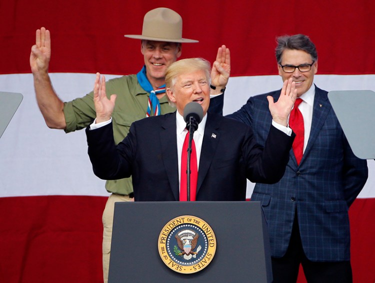 President Trump addresses the 2017 National Boy Scout Jamboree on July 24 while former boys scouts, Interior Secretary Ryan Zinke, left, and Energy Secretary Rick Perry stand behind him.