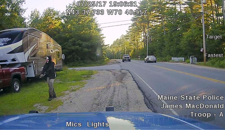 Dashboard camera image released by Maine State Police shows a man later identified as Corey Berry walking along Plains Road in Hollis. 