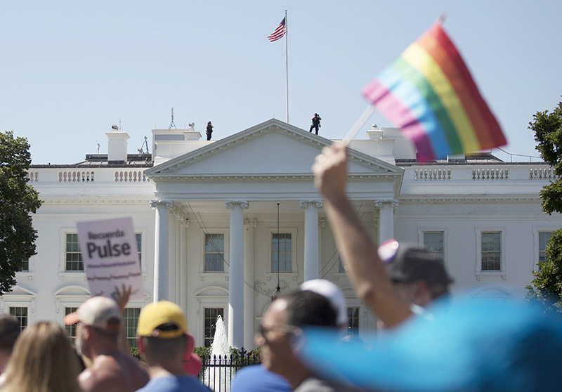 FILE - In this Sunday, June 11, 2017 file photo, Equality March for Unity and Pride participants march past the White House in Washington. Most LGBT-rights activists never believed Donald Trump's campaign promises to be their friend. With his move to ban transgender people from military service on Wednesday, July 26, 2017, on top of other actions and appointments, they now see him as openly hostile. (AP Photo/Carolyn Kaster)