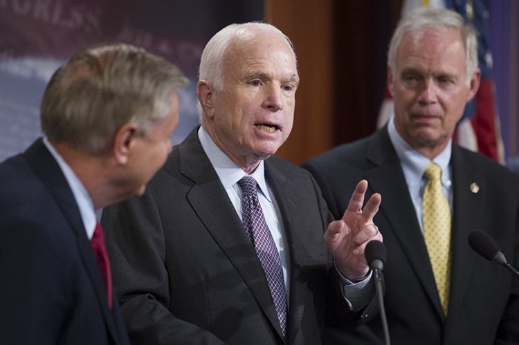 From left, Sen. Lindsey Graham, R-S.C., Sen. John McCain, R-Ariz., and Sen. Ron Johnson, R-Wis., speak to reporters at the Capitol Thursday afternoon.