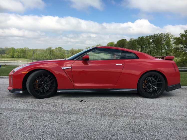 The Nissan GT-R in solid red, updated for 2017, is an AWD-supercar with a 565-horsepower twin-turbo V-6 engine that is stunning on the track and comfortable on the road. 