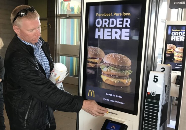Gorham Road McDonald's owner James Nygren demonstrates functions on a new ordering kiosk.