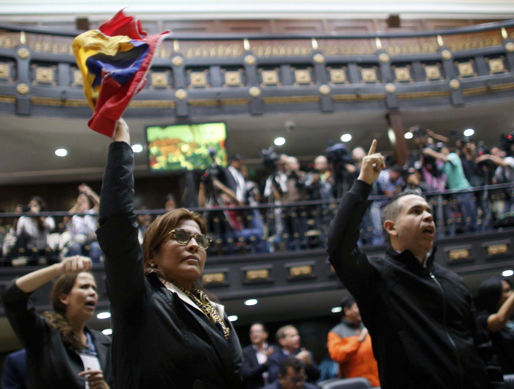 Anti-government lawmakers shout "fraud," at Venezuela's National Assembly in Caracas on Wednesday. The National assembly and a tech CEO say results were tampered with.