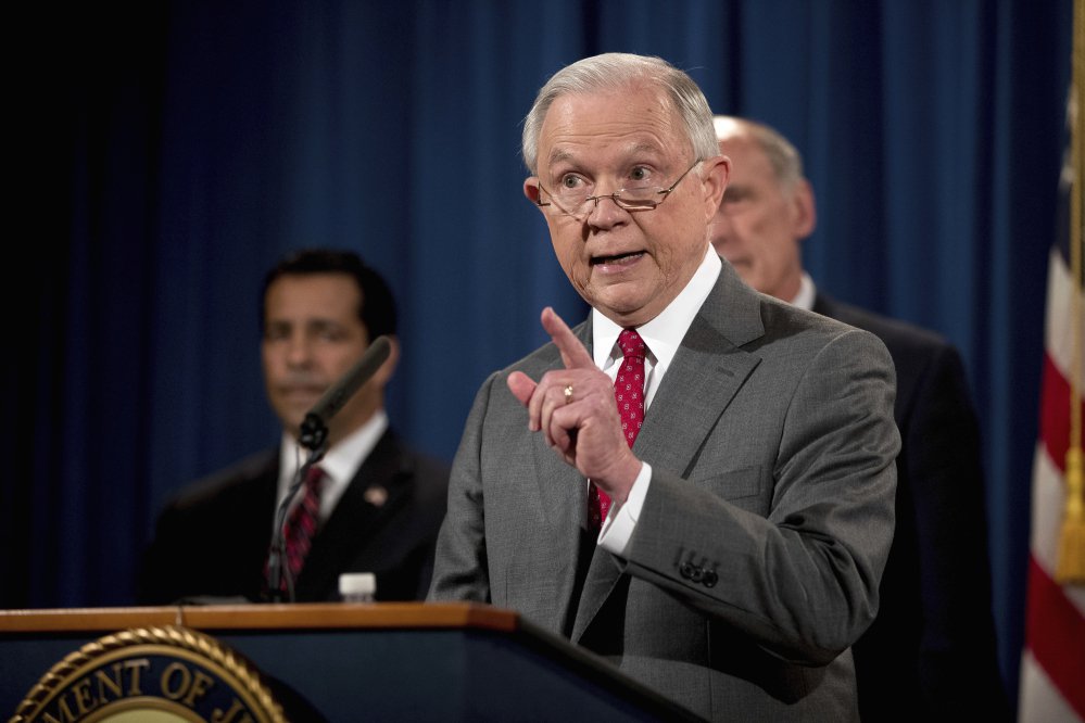 Attorney General Jeff Sessions, accompanied by, from left, National Counterintelligence and Security Center Director William Evanina and Director of National Intelligence Dan Coats, speaks at the Justice Department on Friday about a crackdown on leaks of government information.