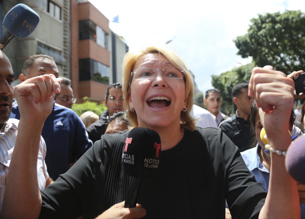 Venezuelan General Prosecutor Luisa Ortega Diaz speaks to the media outside her office. She was unanimously voted out of office and replaced with a government loyalist.