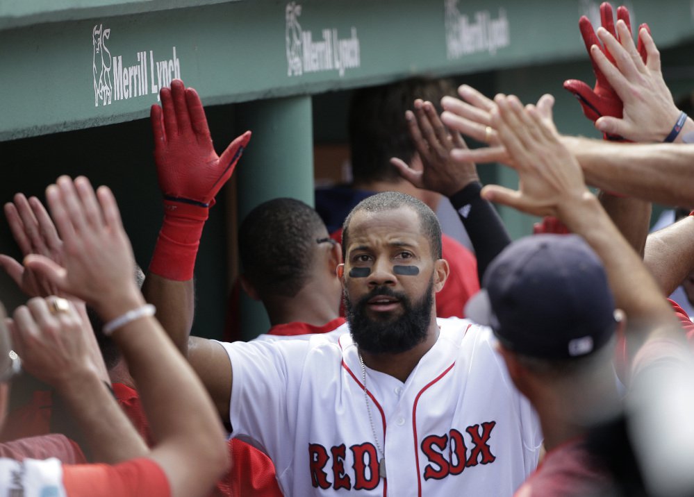 Red Sox's Chris Young is welcomed into the dugout after hitting a three-run home run off a pitch by Chicago White Sox's Mike Pelfrey in the fifth inning Sunday in Boston.