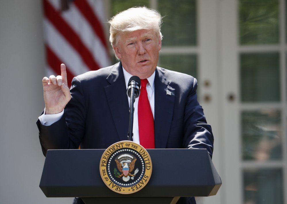 President Trump speaks about the U.S. role in the Paris climate change accord in the Rose Garden of the White House in Washington in June. The White House is currently reviewing a new federal report linking climate change and human activity.