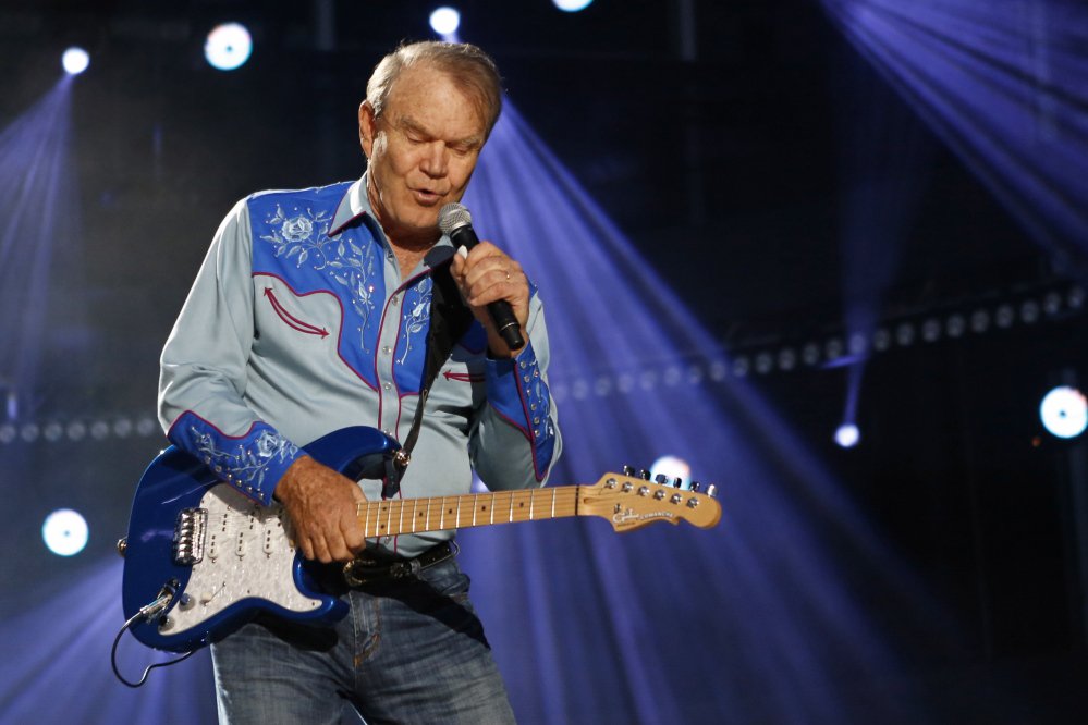American country music artist Glen Campbell performs during the Country Music Association Music Festival in Nashville, Tennessee, in 2012. He died in 
August at age 81 after a battle with Alzheimer's disease. His hits included "Rhinestone Cowboy" and his appeal spanned country, pop, television and movies.