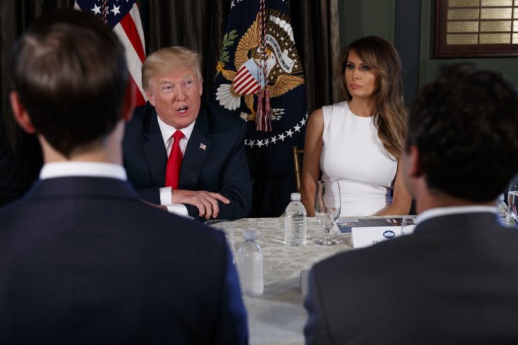 First lady Melania Trump sits at right as President Trump speaks during a briefing on the opioid crisis on Tuesday at the Trump National Golf Club in Bedminster, N.J., where the president is spending a 17-day "working vacation."