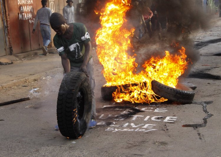 Supporters of Kenyan opposition leader and presidential candidate Raila Odinga demonstrate in the Kibera slum and block roads with burning tires in Nairobi on Wednesday.