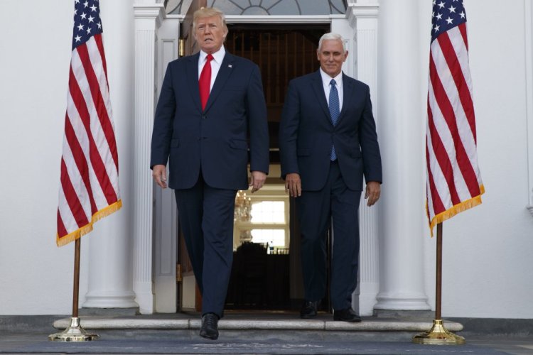 President Trump, accompanied by Vice President Pence, arrives to speak with reporters before a security briefing at Trump National Golf Club in Bedminster, New Jersey on Thursday.
