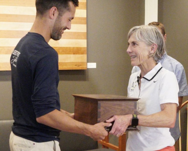 Joan Benoit Samuelson presents a Thos. Moser Beacon Box to Rob Gomez on Thursday. Boxes are given to the winners in each division of the TD Beach to Beacon 10K road race, and in this case honored Gomez's selfless assistance to fellow runner Jesse Orach.