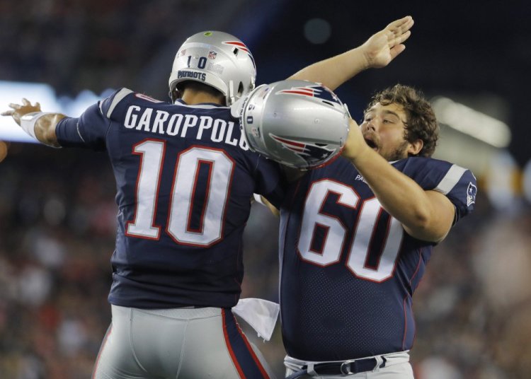 Patriots center David Andrews (60) celebrates with quarterback Jimmy Garoppolo after a New England touchdown against the Jacksonville Jaguars in the second quarter Thursday night at Gillette Stadium. Jacksonville held on for a 31-24 win in both teams' preseason opener.