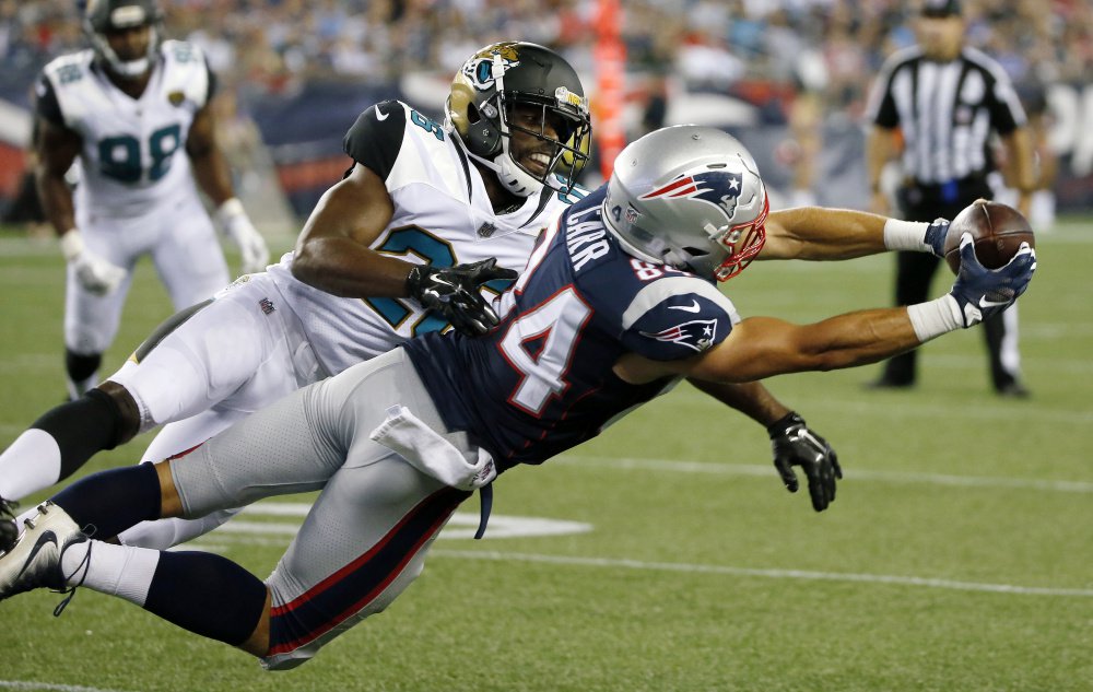 Patriots wide receiver Austin Carr stretches for a catch in front of Jaguars cornerback Doran Grant in the second half of Thursday night's game in Foxborough, Mass.