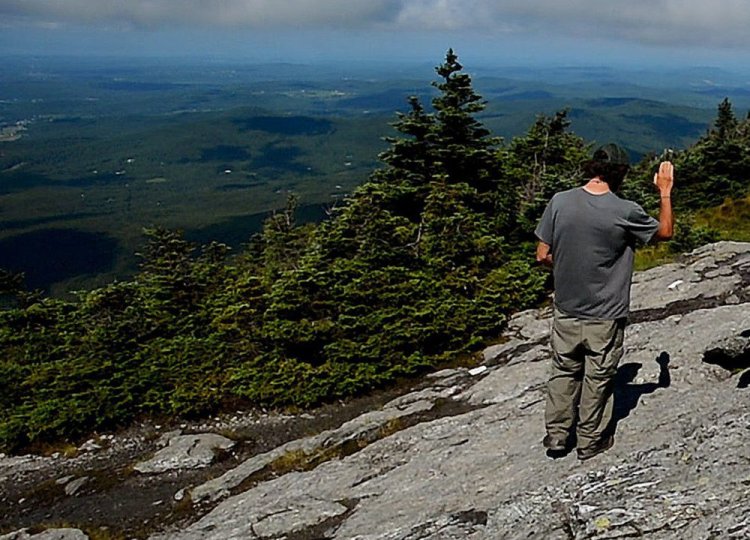 Adam Joseph of the Green Mountain Club talks to hikers new to Vermont's Mount Mansfield in July. "It's everywhere up there," Joseph said of cremation ashes on another peak in Camels Hump State Park. Vermont's cremation rate was nearly 70 percent in 2016.