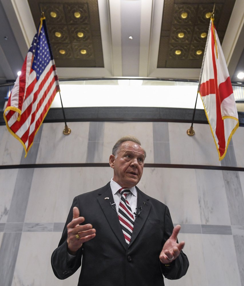 FILE - In this Wednesday, Aug. 9, 2017, file photo, U.S. Senate candidate Roy Moore holds a press conference in Montgomery, Ala. In the Alabama race for Attorney General Jeff Sessions' former Senate seat, the Republican slugfest primary is about love of all things Trump, with contenders openly wooing Trump voters, and hatred of the so-called swamp of Washington D.C. Sen. Luther Strange, who was appointed to the position in February, is trying to fight off a field of firebrand challengers, including U.S. Rep. Mo Brooks and Moore in the GOP primary. (Mickey Welsh/The Montgomery Advertiser via AP, File)