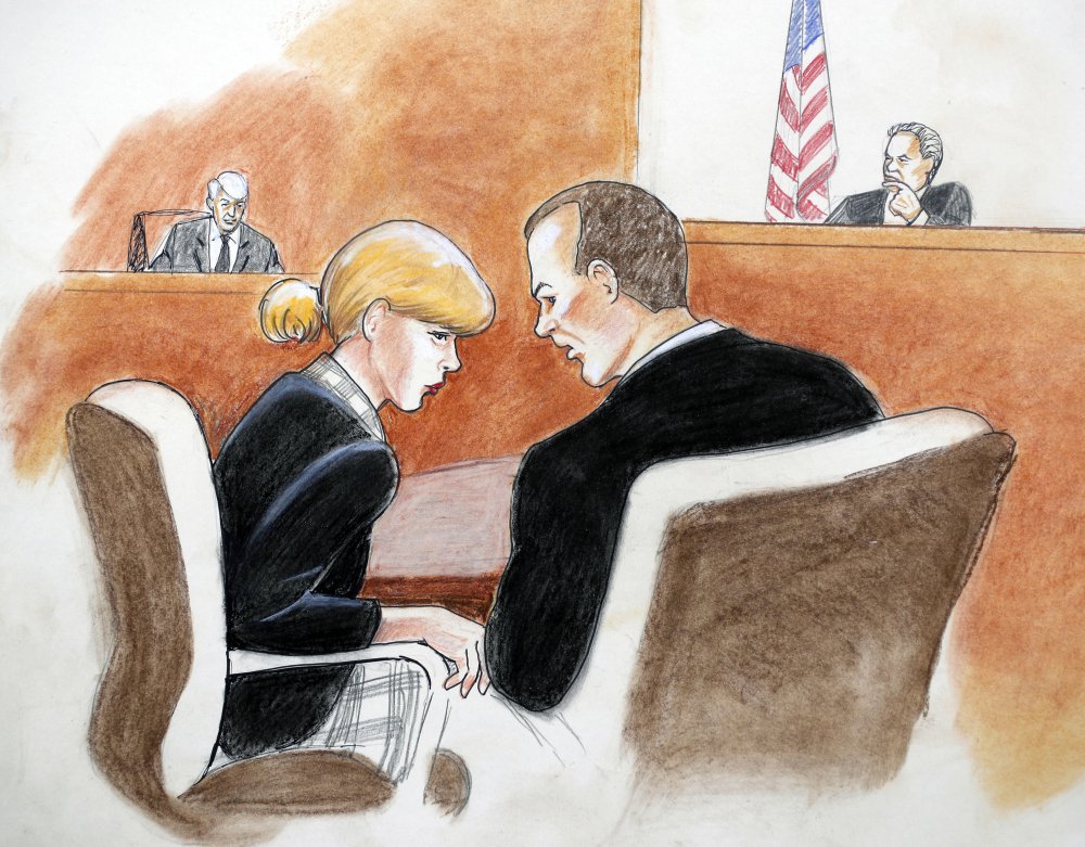 A courtroom sketch shows pop singer-songwriter Taylor Swift conferring with attorney Douglas Baldridge during her trial in Denver.