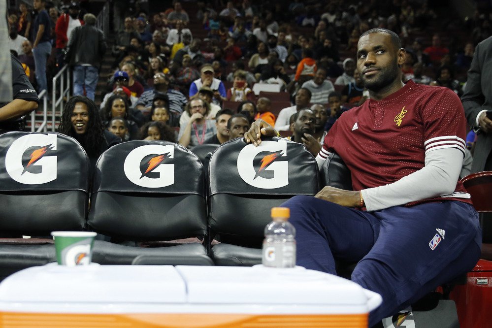 In this Oct. 8, 2015 photo, Cleveland Cavaliers forward LeBron James watches from the bench during a timeout of the second half of a preseason game in Philadelphia.