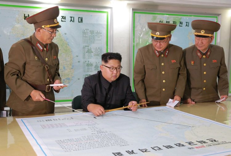 North Korean leader Kim Jong Un, center, talks with military commanders during his visit to Korean People's Army's Strategic Forces in North Korea. The Korean Central News Agency said Tuesday that Kim, during an inspection of the KPA's Strategic Forces, praised the military for drawing up a "close and careful" plan.