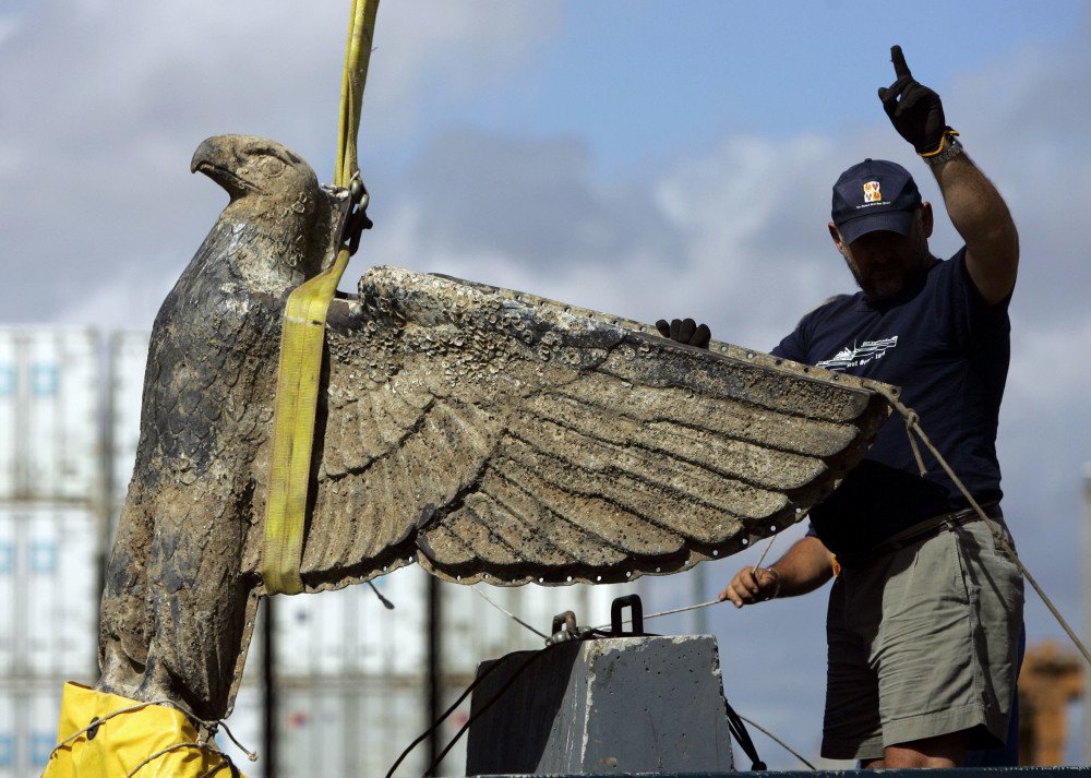 A Uruguayan worker directs the salvage of a Nazi bronze eagle, which has a swastika under its claws, from the German battleship Admiral Graf Spee in Montevideo in 2006.