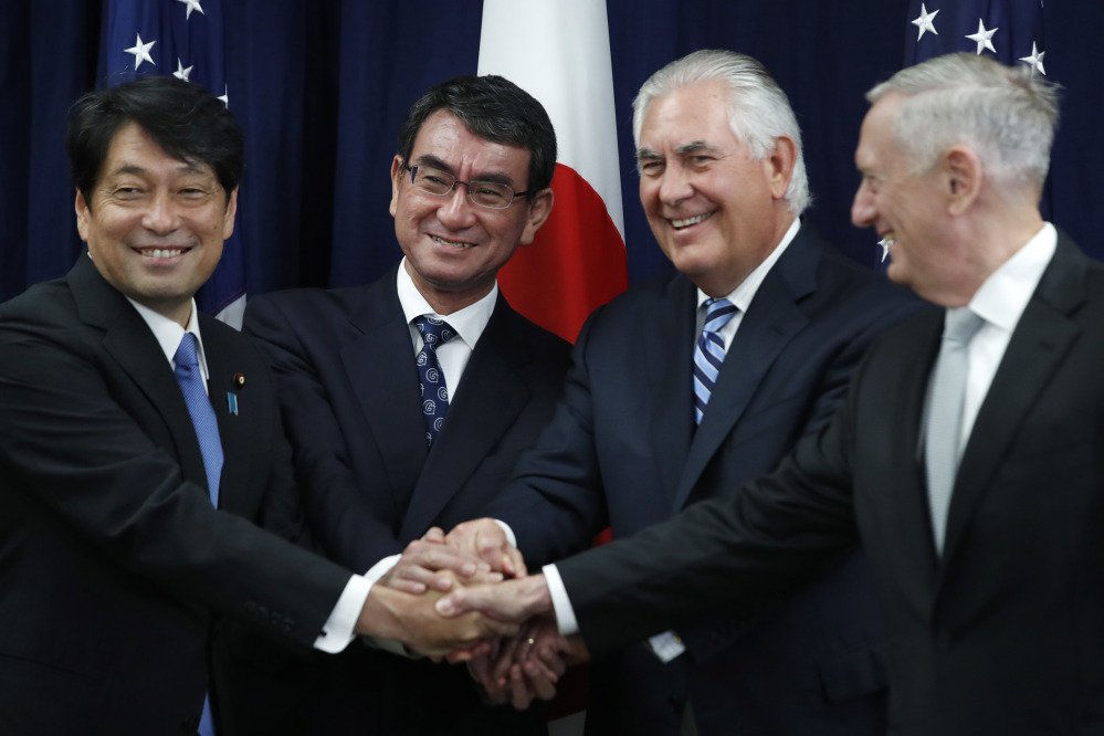 From left, Japanese Defense Minister Itsunori Onodera, Japanese Foreign Minister Taro Kono, Secretary of State Rex Tillerson and Defense Secretary James Mattis shake hands at the start of a Security Consultative Committee meeting on Thursday.
