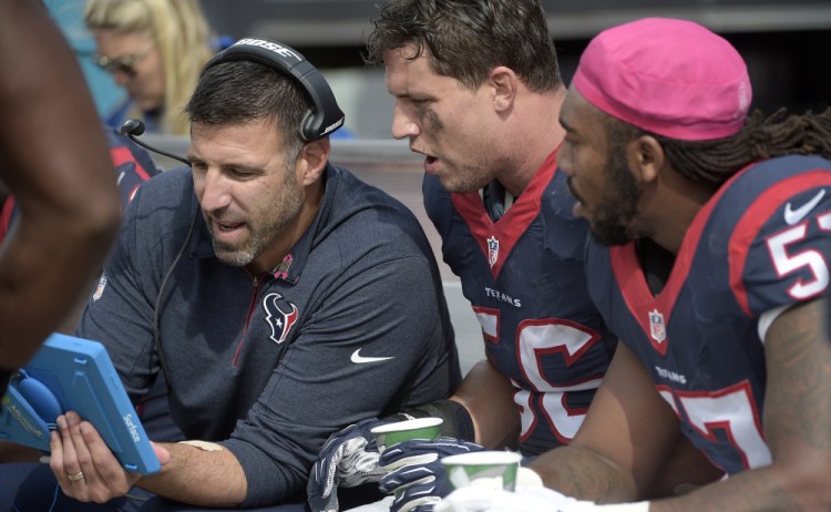 Mike Vrabel, left, once a standout linebacker for New England, spent three seasons coaching Houston linebackers, such as Brian Cushing, center, and Justin Tuggle, and earned himself a promotion to defensive coordinator.