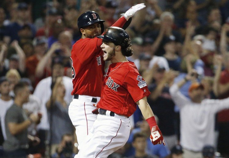 Boston's Andrew Benintendi, right, and Eduardo Nunez celebrate after scoring on a two-run single by Mitch Moreland in the seventh inning Friday night against the Yankees at Fenway Park.