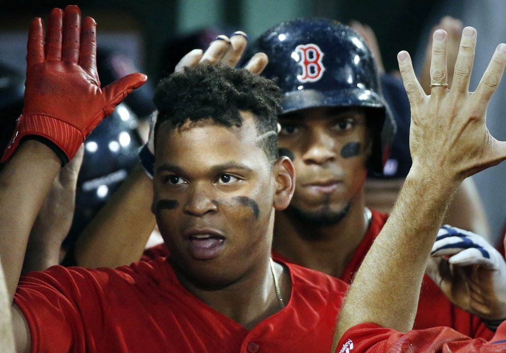 Rafael Devers celebrates his two-run homer Friday night against the New York Yankees. Devers, 20, went into Saturday night's game with seven home runs and a .356 batting average in his first 19 games for the Red Sox.