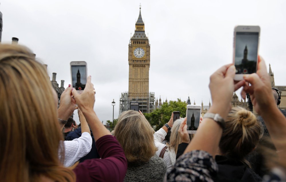 People record the last bell bong at Elizabeth Tower in London on Monday. At noon, Big Ben's famous bongs sounded for the last time before major renovation work is performed.