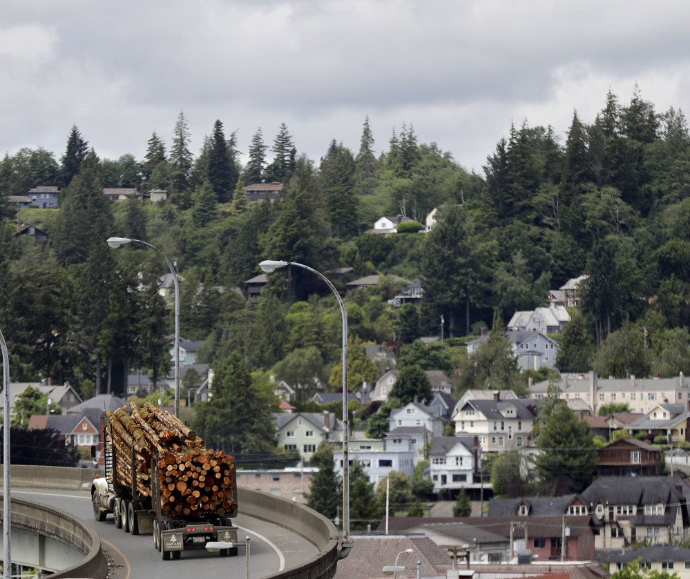 A logging truck makes its way through Aberdeen, Wash. The United States is importing more softwood lumber from overseas nations, including from Russia, data indicate.