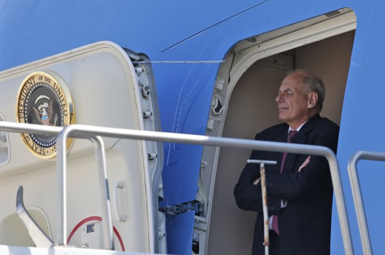 White House Chief of Staff John Kelly stands in the door of Air Force One and watches President Trump, as he arrives in Reno, Nev., on Wednesday.