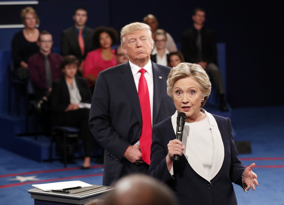 During a moment in the Oct. 9, 2016, debate, Democratic presidential nominee Hillary Clinton speaks as Republican presidential nominee Donald Trump stands behind her.