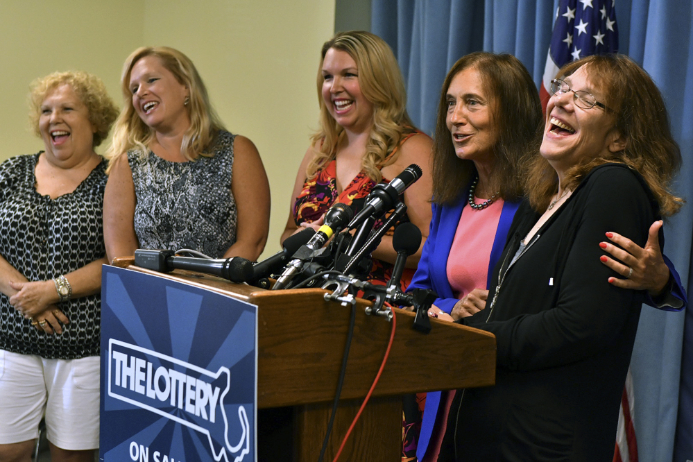 Mavis Wanczyk, right, of Chicopee, Mass., laughs beside state Treasurer Deb Goldberg during a news conference where she claimed the $758.7 million Powerball prize at Massachusetts State Lottery headquarters on Thursday in Braintree, Mass. At left are Wancyk's mother and two sisters.