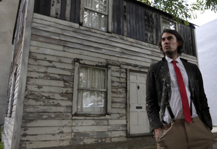 American artist Ryan Mendoza poses in front of the rebuilt house of Rosa Parks which he saved and moved to Berlin. 