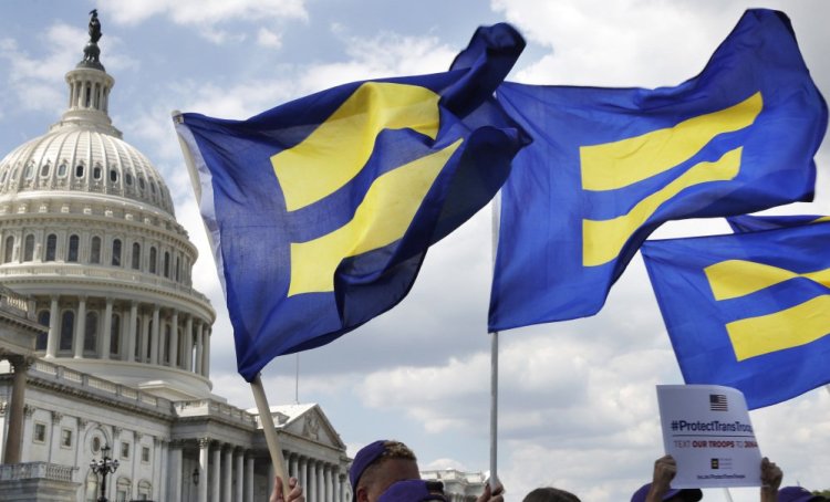 People with the Human Rights Campaign hold up "equality flags" during an event on Capitol Hill in Washington in July in support of transgender members of the military.