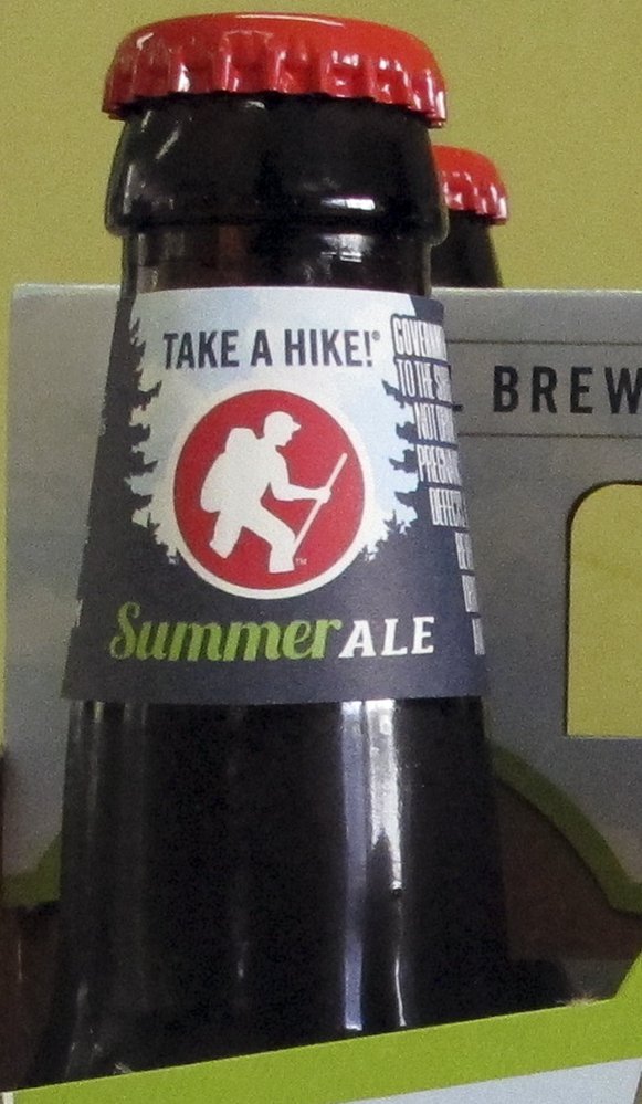 A label with the slogan "Take a Hike" wraps the neck of a Long Trail Brewing Co. beer at Elm Street Market in Montpelier, Vt., on Friday.