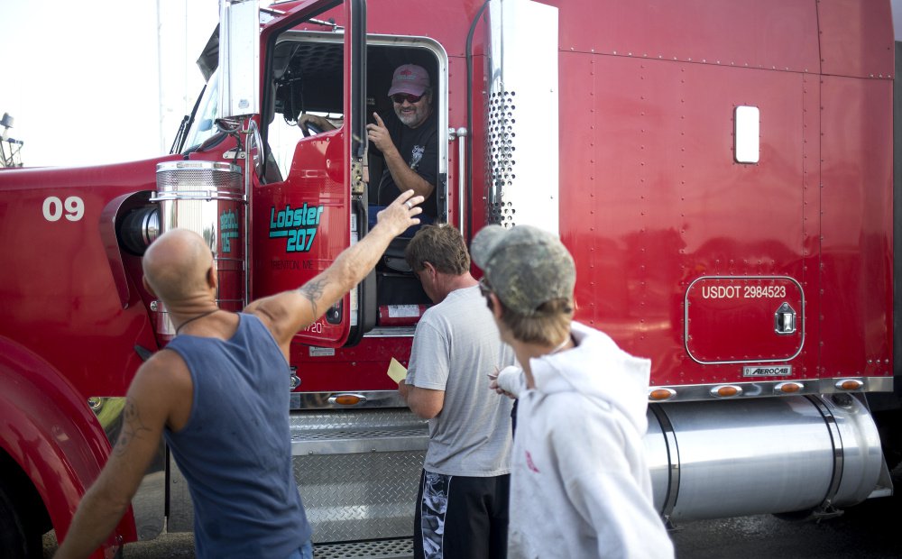 Dwayne Bradford, a union driver, waves to the Fox Island Lobstering crew after loading their union-caught lobster from Vinalhaven onto a union truck. 