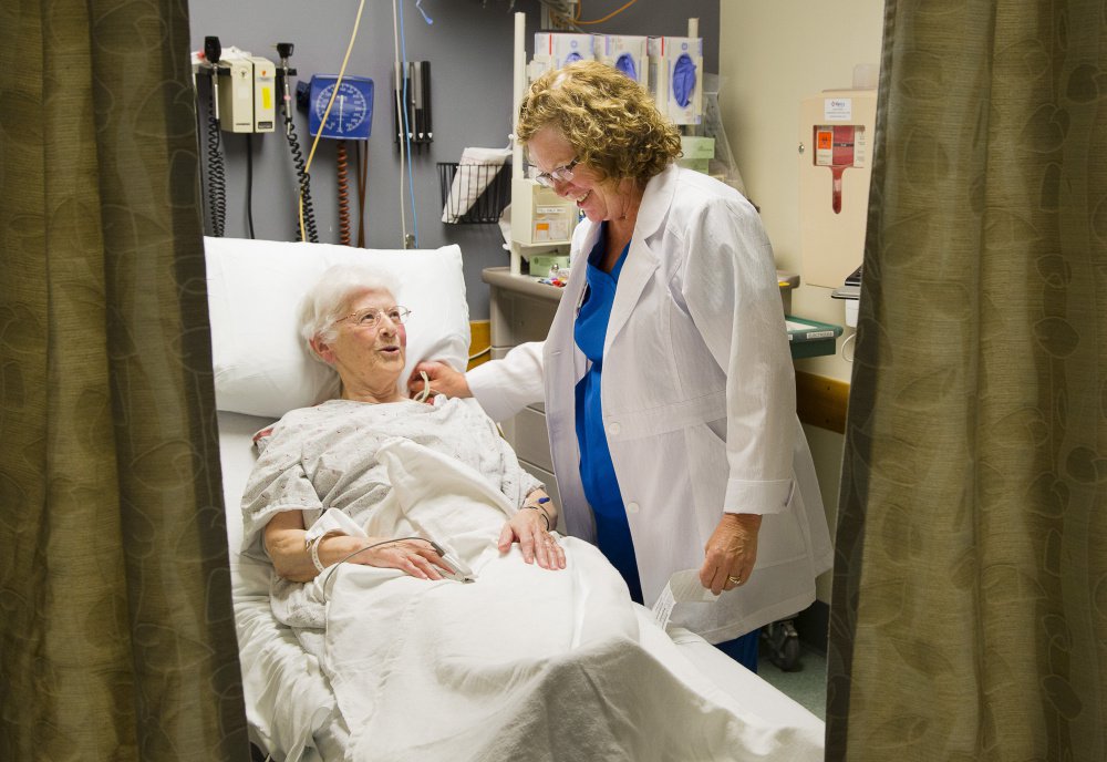 Emergency Room nurse Katie Johnson looks after Sister Margaret Cushman at Mercy Hospital in Portland recently. Administrators at both Mercy and Maine Medical Center say they're working on long-term solutions to the growing shortage of nurses, including innovative recruitment programs.