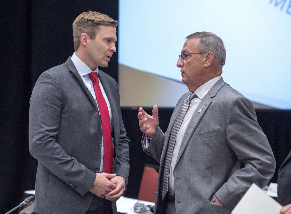 New Brunswick Premier Brian Gallant, left, and Maine Governor Paul LePage chat at the start of a meeting of New England governors and Eastern Canadian premiers in Charlottetown, Prince Edward Island, on Monday, Aug. 28, 2017. (Andrew Vaughan/The Canadian Press via AP)