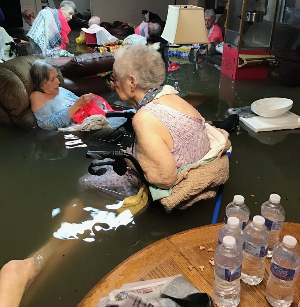 Residents of the La Vita Bella nursing home in Dickinson, Texas, sit in waist-deep flood waters caused by Hurricane Harvey. Authorities said all the residents were safely evacuated from the facility on Monday.