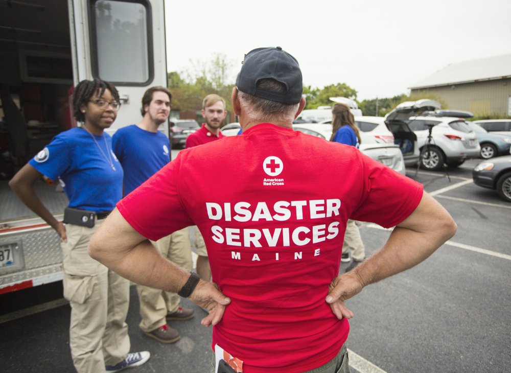Red Cross volunteer Bill Thomas speaks to FEMA Corps workers in Portland.