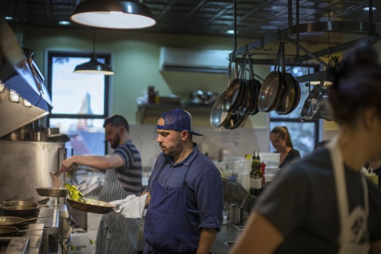 Chef Anders Tallberg works in the kitchen at the newly reopened Roma Cafe in Portland.