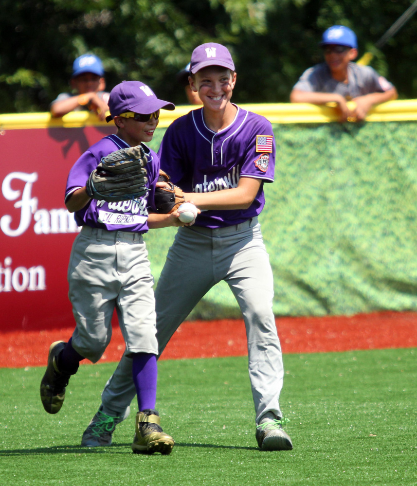 Waterville left fielder John Nawfel, left, gets congratulated by center fielder Spencer Brown after making a catch to end the third inning in a Cal Ripken 11U New England regional quarterfinal game Tuesday against Barrington, New Hampshire at Purnell Wrigley Field in Waterville. Waterville won 8-1.