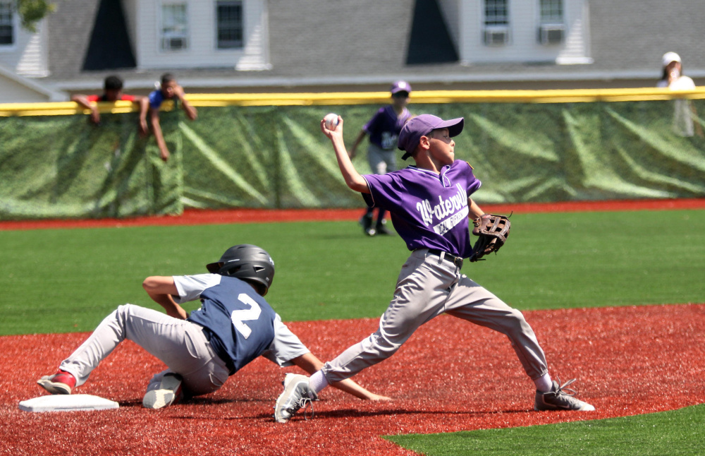 Waterville second baseman Jon Roach tries to turn a double play as Barrington, New Hampshire baserunner Jon Pelletier, left, slides into second base during a Cal Ripken 11U New England regional quarterfinal game Tuesday at Purnell Wrigley Field in Waterville. Waterville won 8-1.
