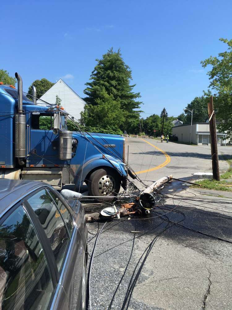 A tractor-trailer snagged power lines on Maple Street in Waterville, breaking two utility poles, sending a transformer crashing to the pavement and cutting power to about 280 Central Maine Power Co. customers.