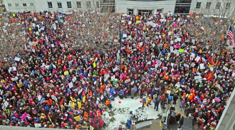 Thousands of people gather on Jan. 21 between the Burton M. Cross State Office Building and the State House for the Women's March on Maine in Augusta.