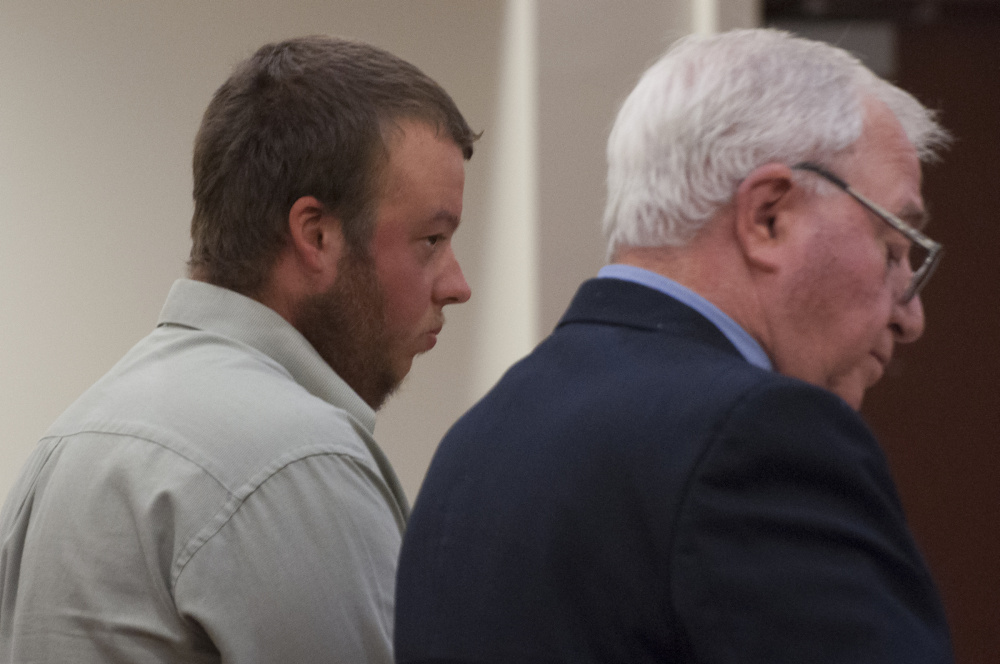 Alexander Biddle, 23, of Pittston stands at his arraignment on a manslaughter charge with his attorney Pasquale Perrino at the Capital Judicial Center in Augusta on Thursday.