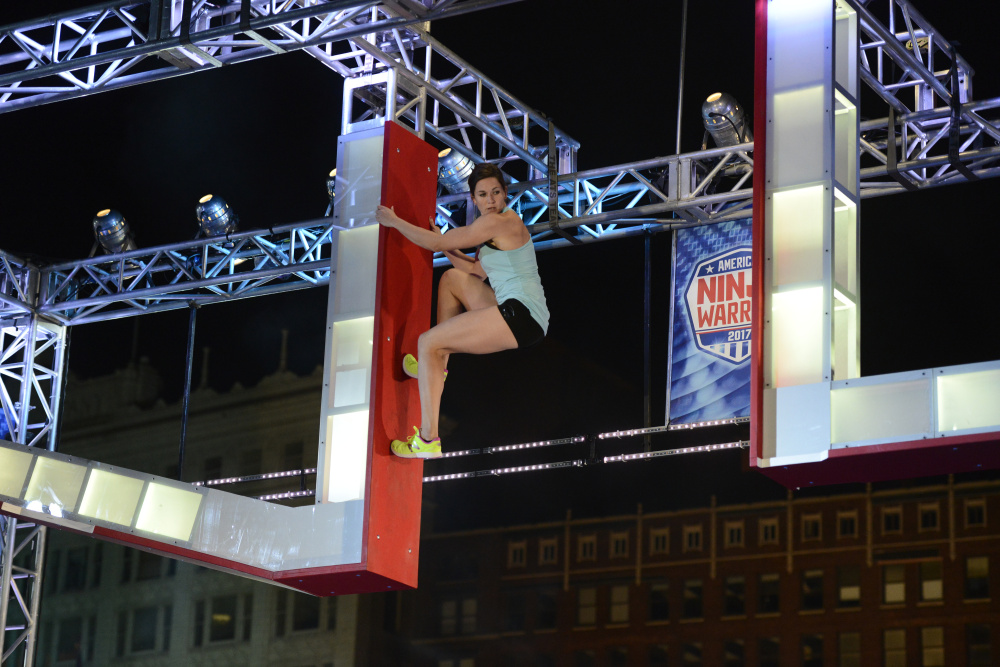 Jesse Labreck hangs on to an apparatus during her run at the "American Ninja Warrior" Cleveland qualifier. Labreck, an Oakland native and Messalonskee High School graduate, qualified for nationals.