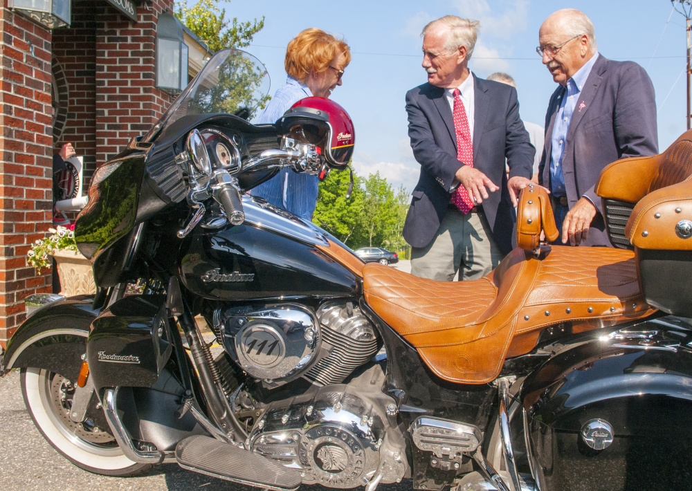 Ellen Crocker, left, Sen. Angus King, independent of Maine, and Gary Crocker talk about the Crockers' Indian motorcycle after King's speech on Wednesday at the Senator Inn and Spa in Augusta. Crocker said that the two men and some other friends are planning a motorcycle trip around Maine this weekend like they used to do when King was the governor.